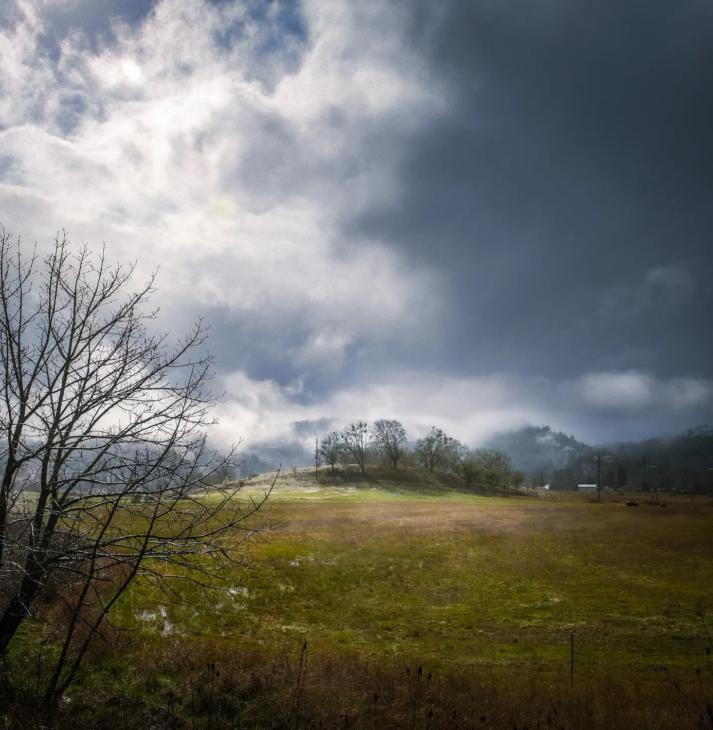rolling hills on a partly sunny stormy day in Roseburg, OR